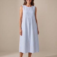 Woman wearing The Adele sleeveless midi dress in blue and white striped linen, front view
