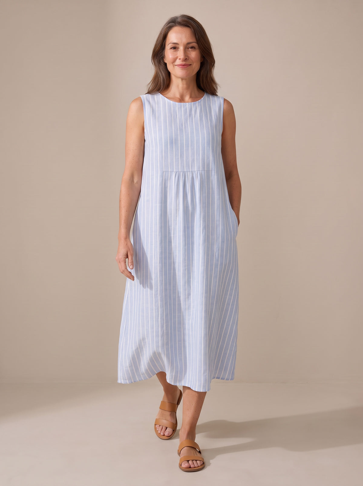 The Adele striped midi dress, walking view showing the relaxed fit and side pocket