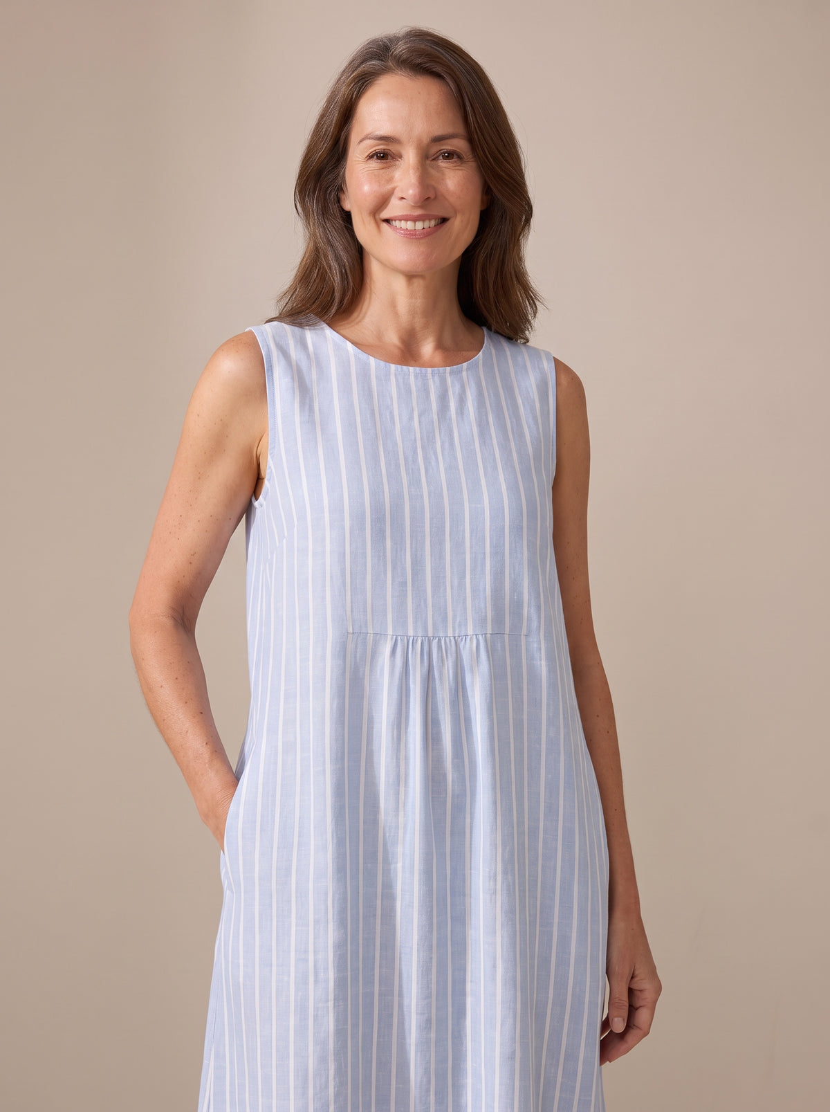 Close-up of The Adele dress round neckline, gathered yoke seam and striped linen texture