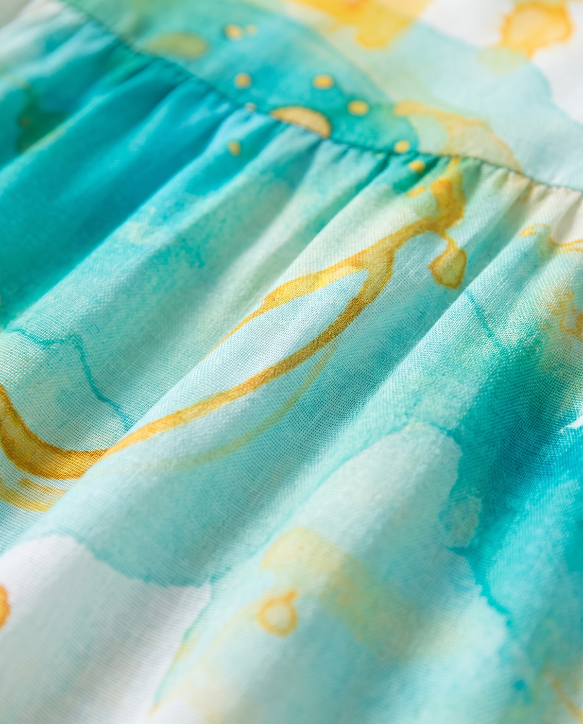 Close-up of the aqua and gold watercolour print