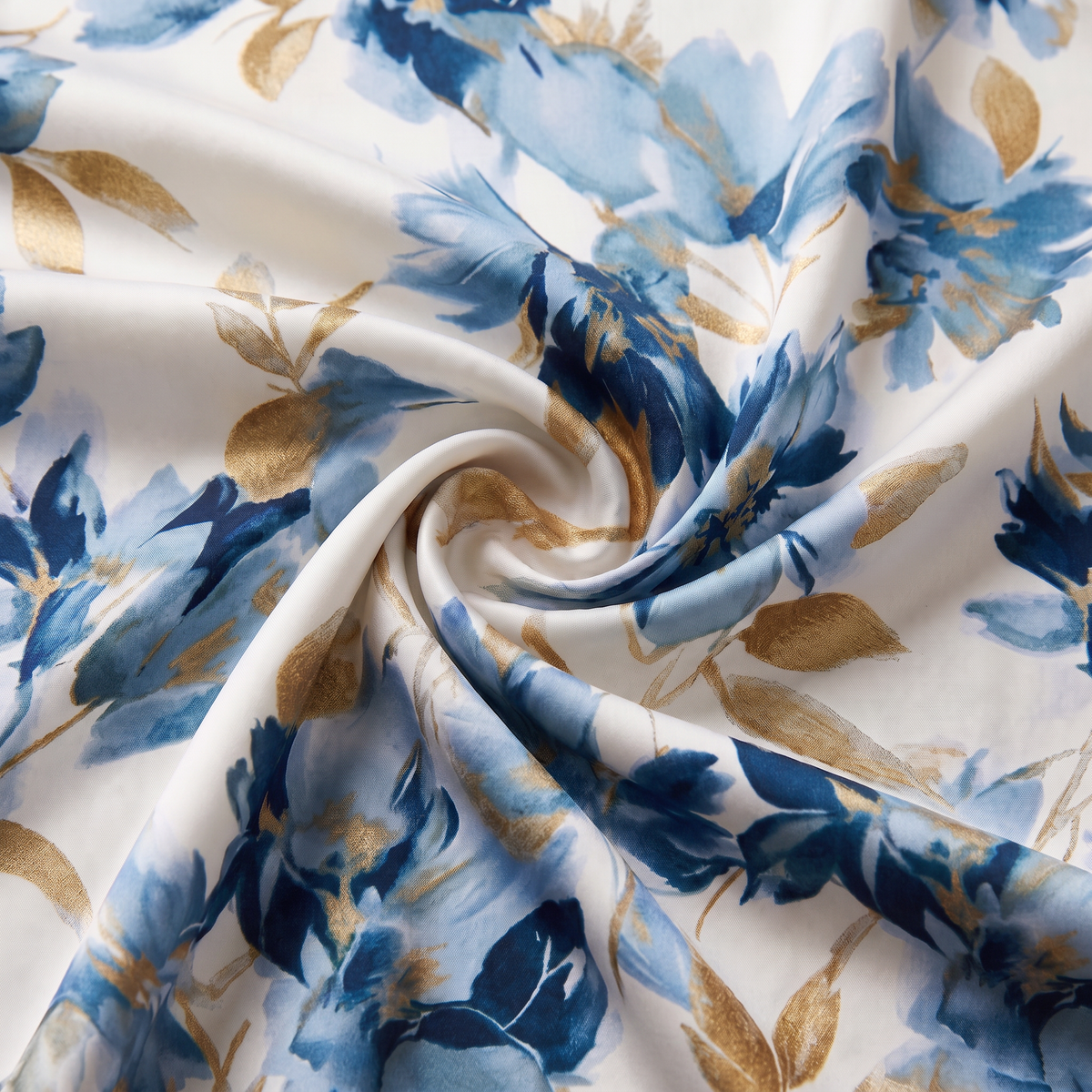Close-up of the blue watercolour floral print with gold leaf accents