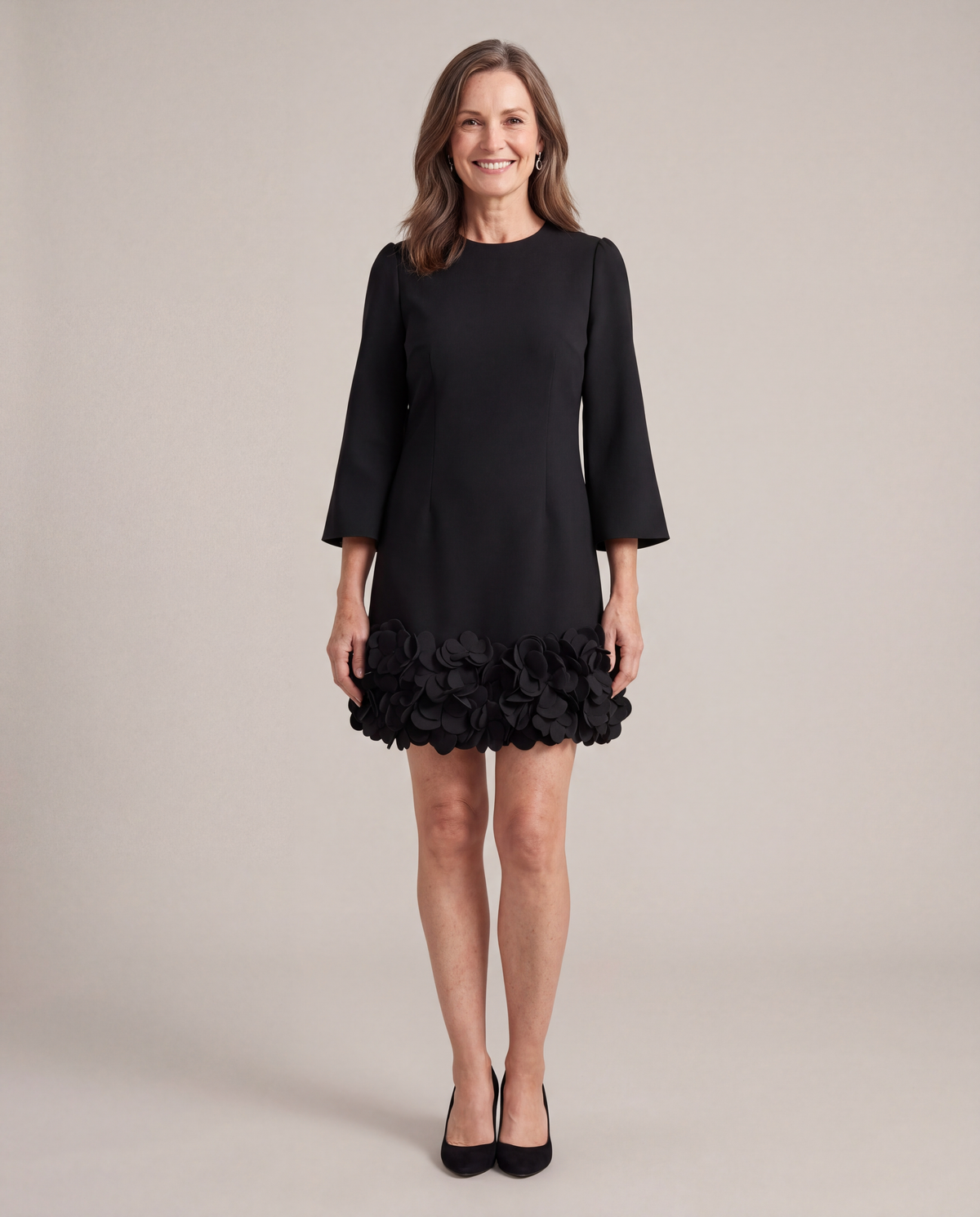 Woman wearing the Solange black petal hem mini dress, front view