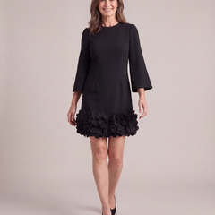 Woman walking in the Solange black petal hem mini dress