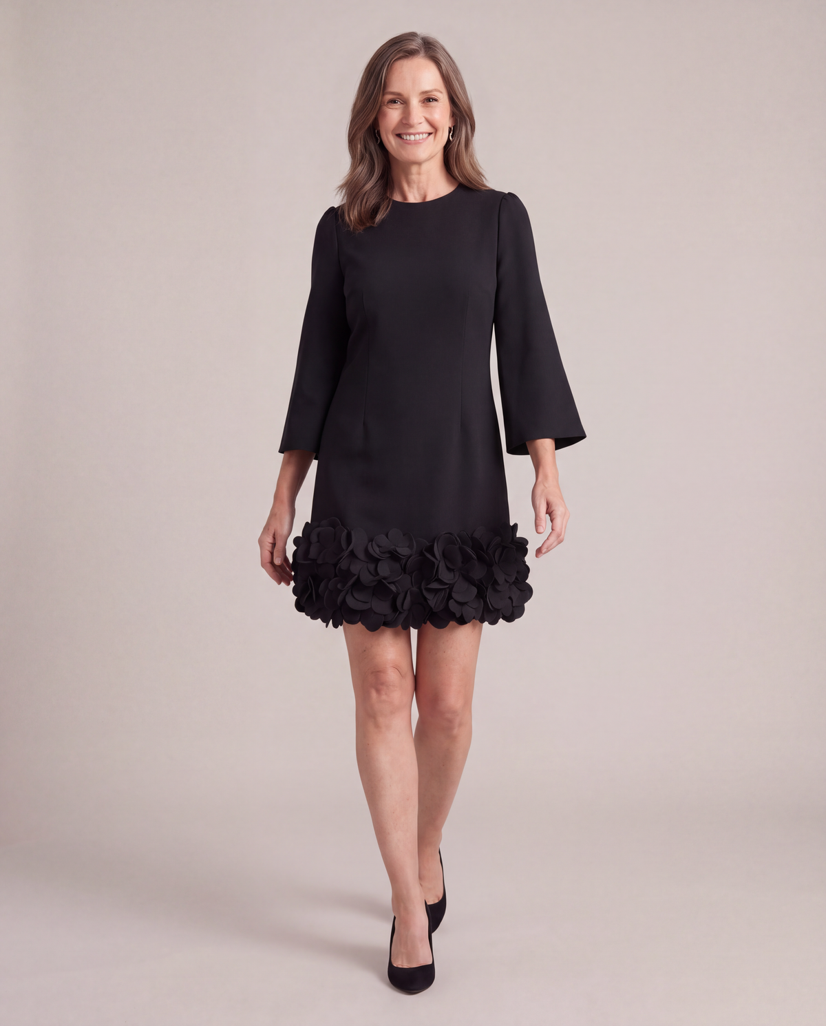 Woman walking in the Solange black petal hem mini dress