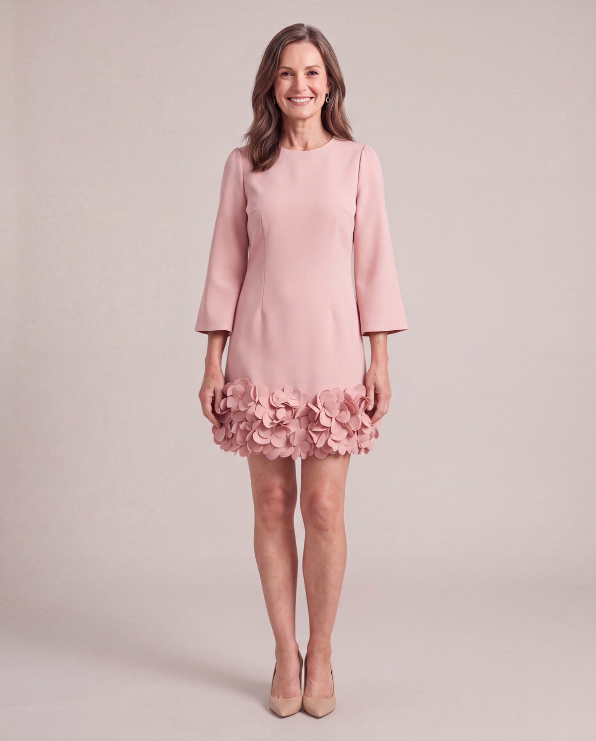 Woman wearing the Solange blush pink petal hem mini dress, front view