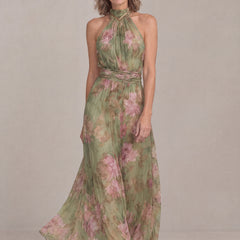 Liora halter maxi dress in green floral chiffon, three-quarter front view with flowing skirt