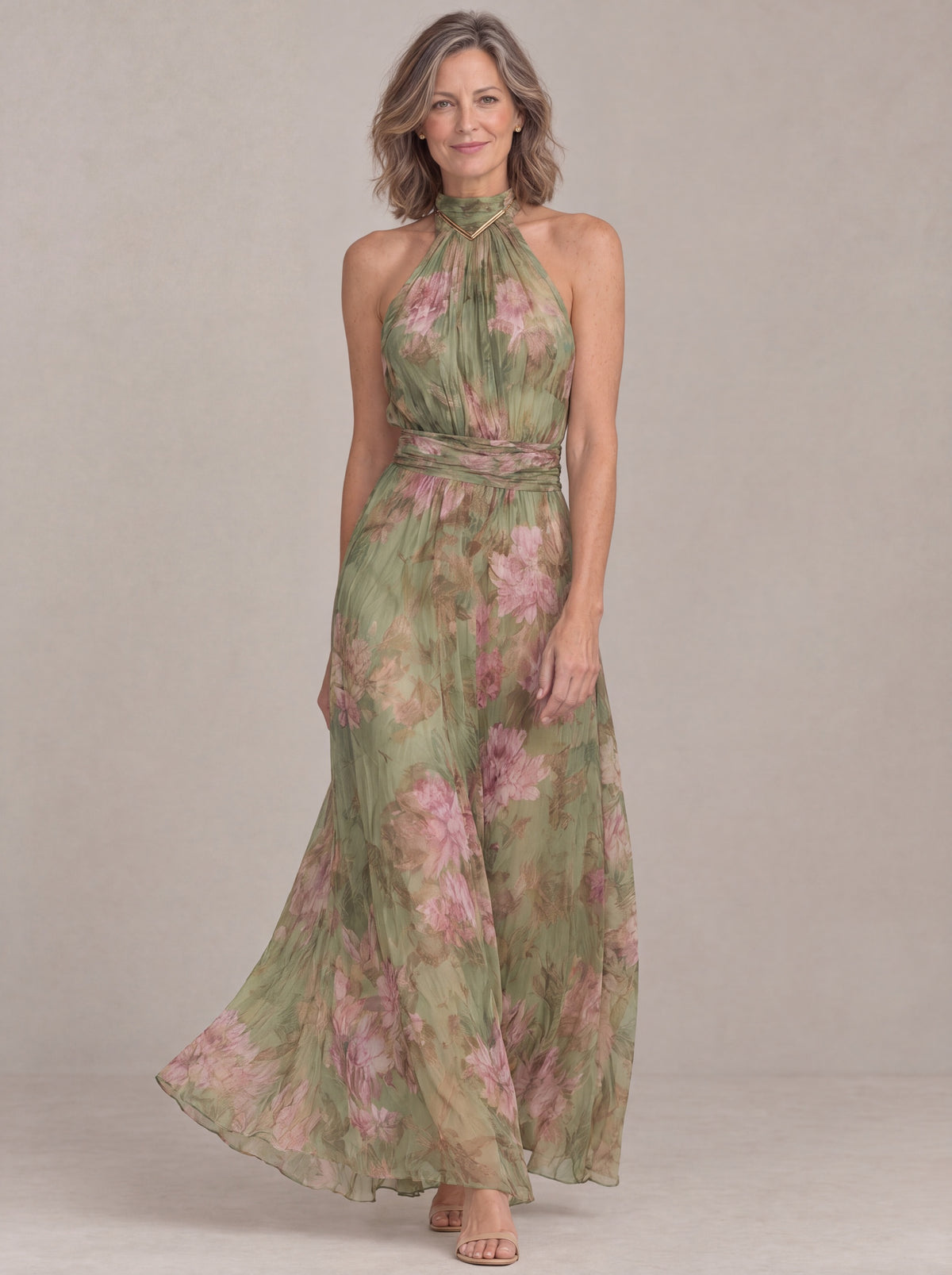 Liora halter maxi dress in green floral chiffon, three-quarter front view with flowing skirt