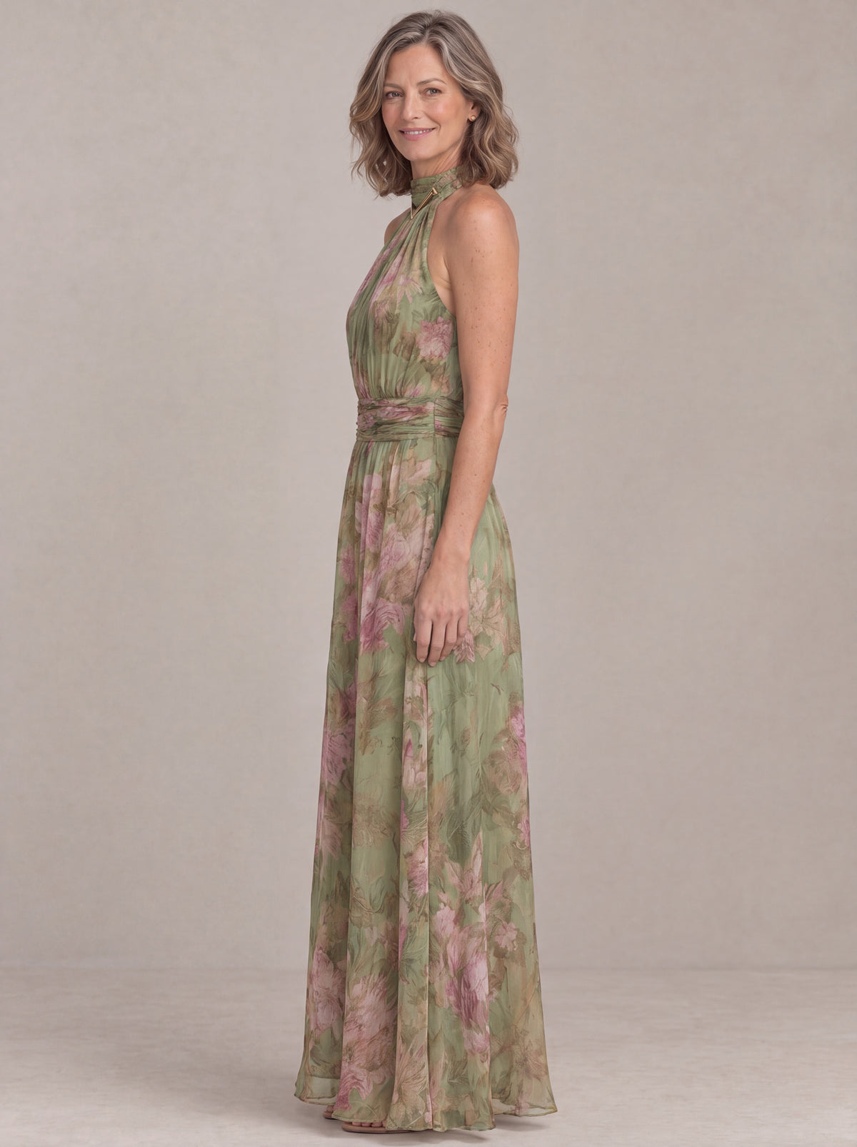 Liora floral halter maxi dress, side view showing the maxi length and gathered waistband