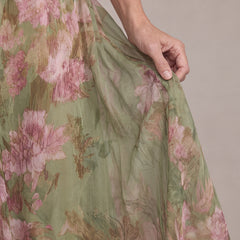 Close-up of the Liora dress sheer chiffon fabric with pink peony print on sage green