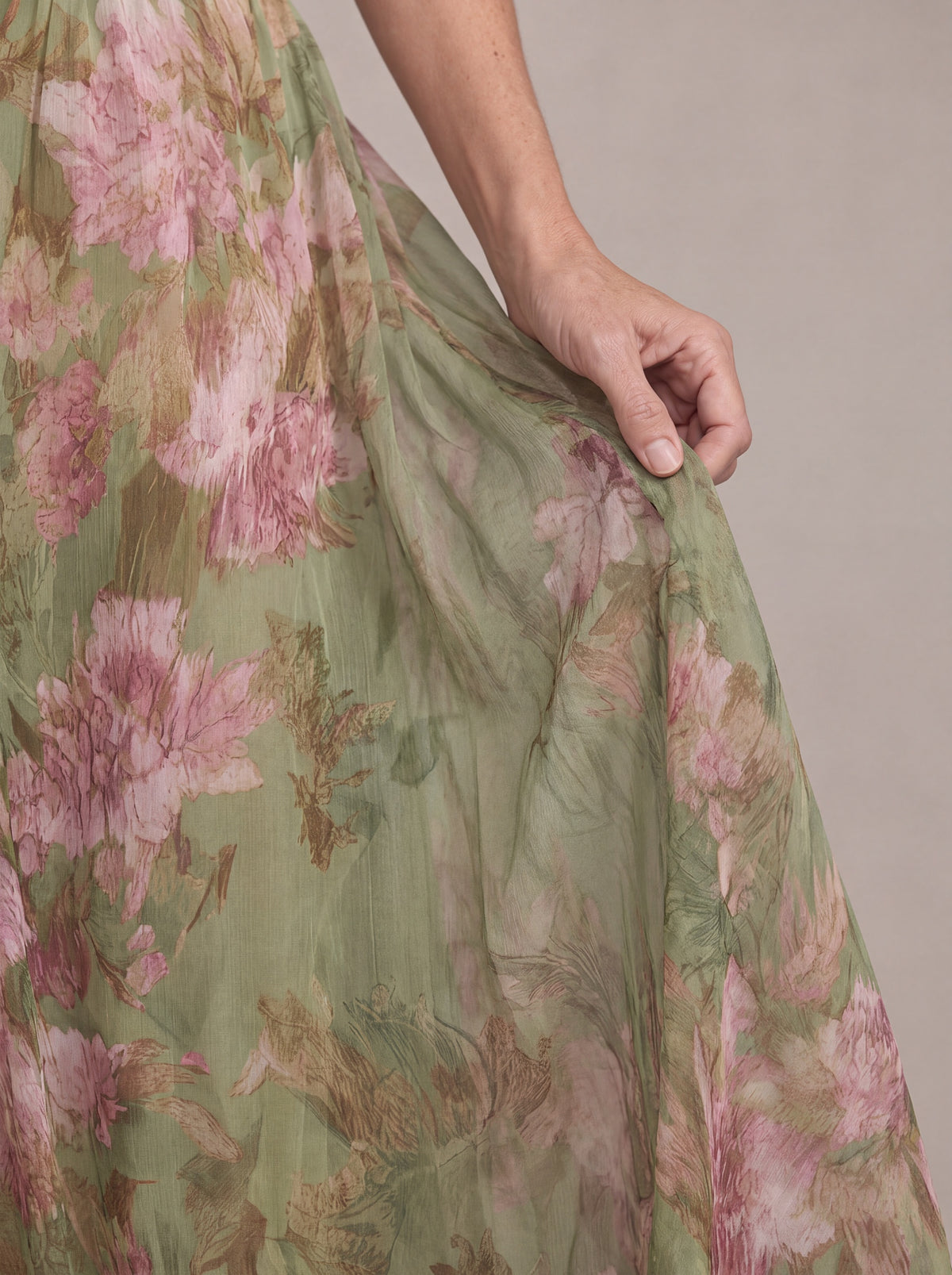 Close-up of the Liora dress sheer chiffon fabric with pink peony print on sage green