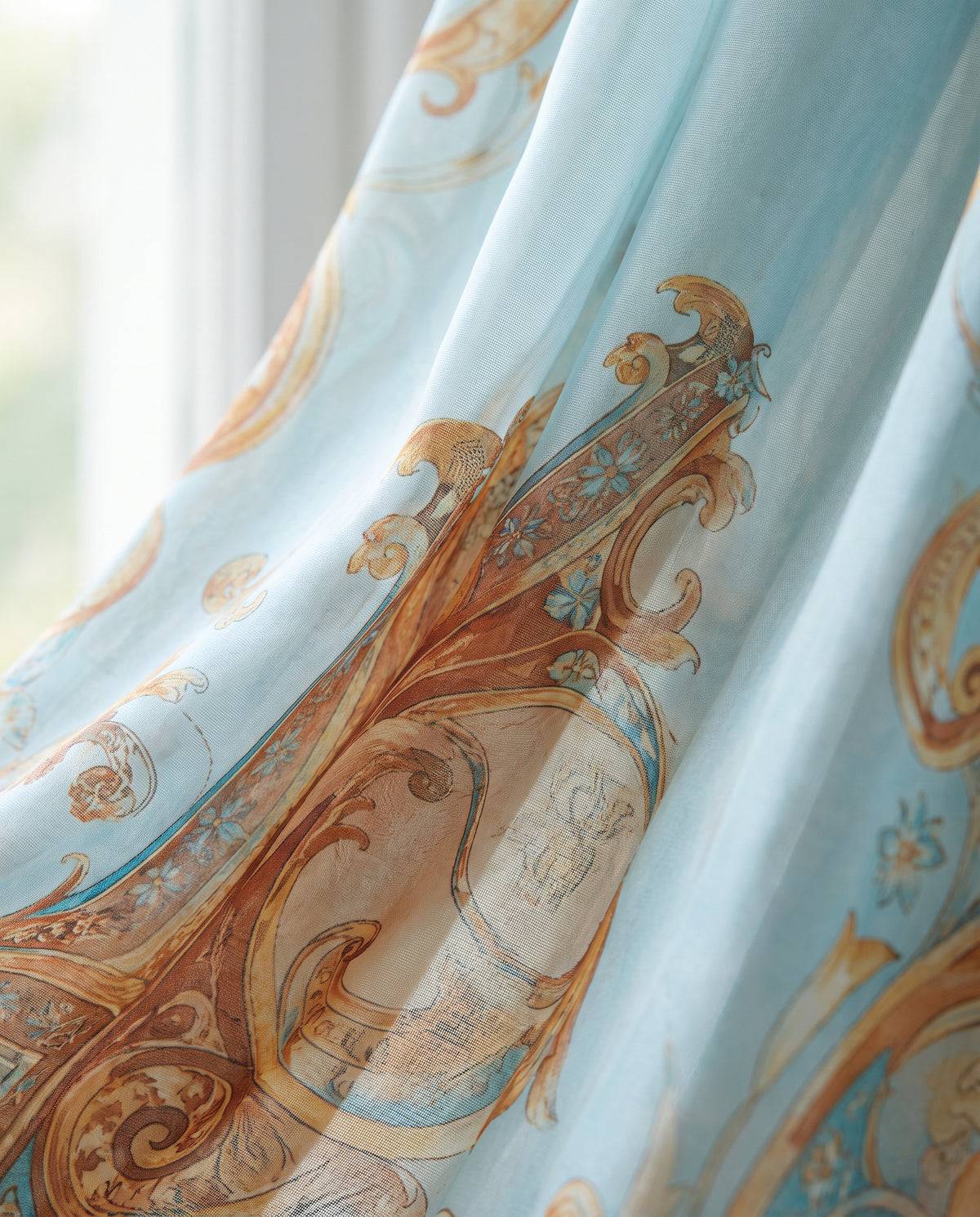 Close-up of the baroque print fabric in sky blue, terracotta and gold