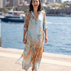 Woman laughing in the Ottavia maxi dress by the harbour