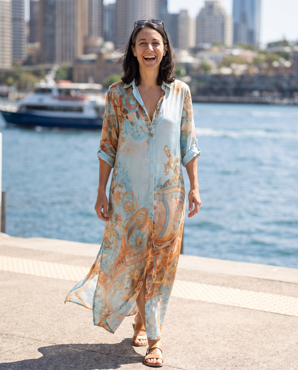Woman laughing in the Ottavia maxi dress by the harbour