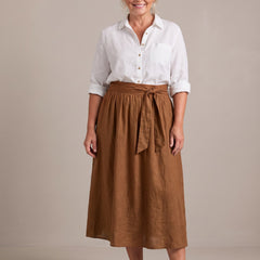 Rosalind set in white shirt and brown skirt