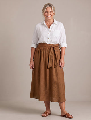 Rosalind set in white shirt and brown skirt