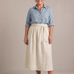Rosalind set in light blue shirt and cream skirt