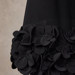 Fabric detail of the layered 3D petal hem on the Solange black mini dress