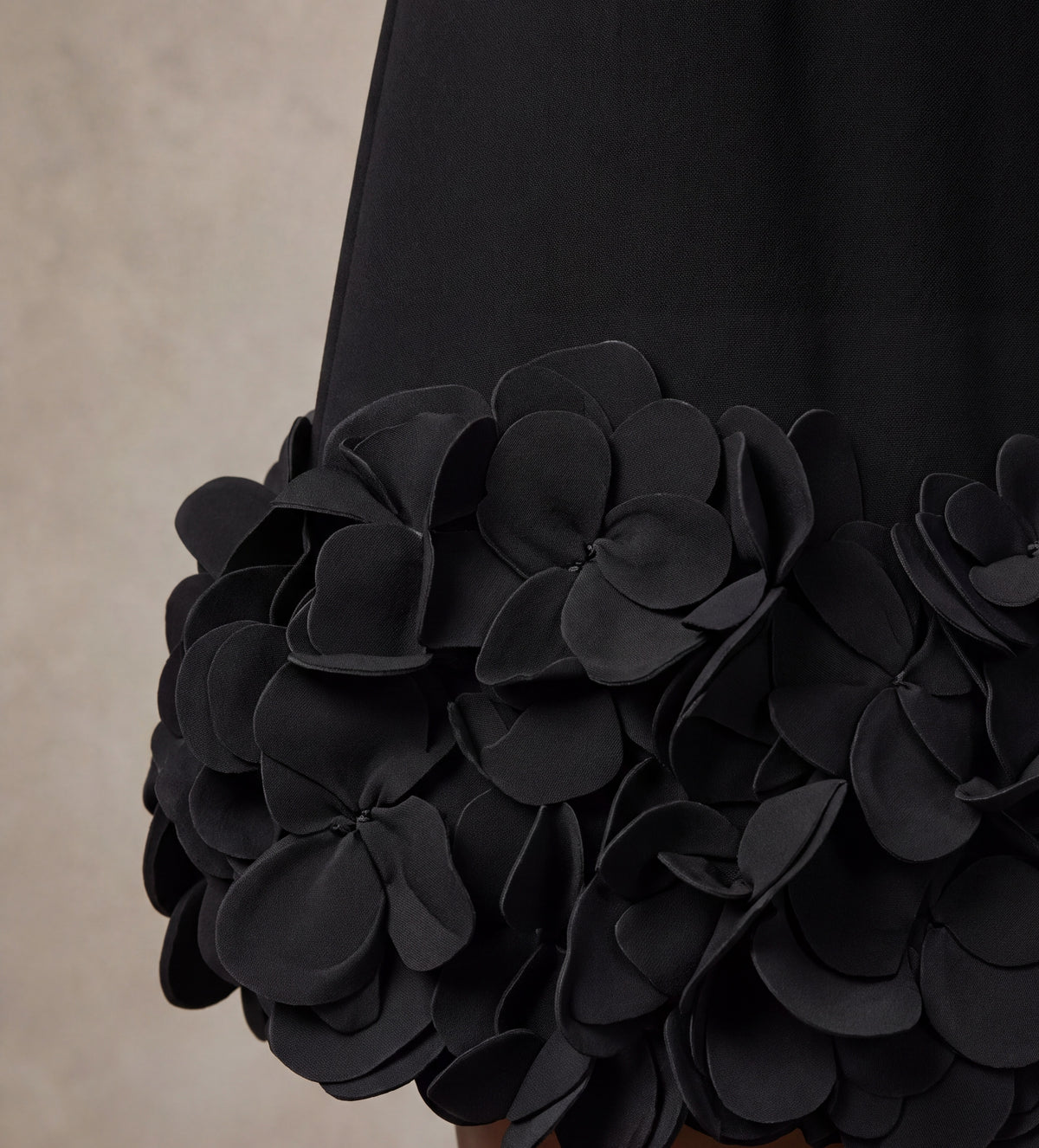 Fabric detail of the layered 3D petal hem on the Solange black mini dress